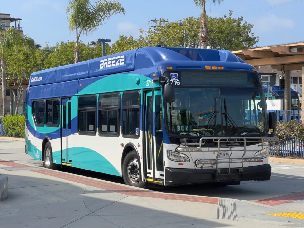A Breeze bus in Oceanside, CA, parked under clear skies. Perfect for public transport themes.