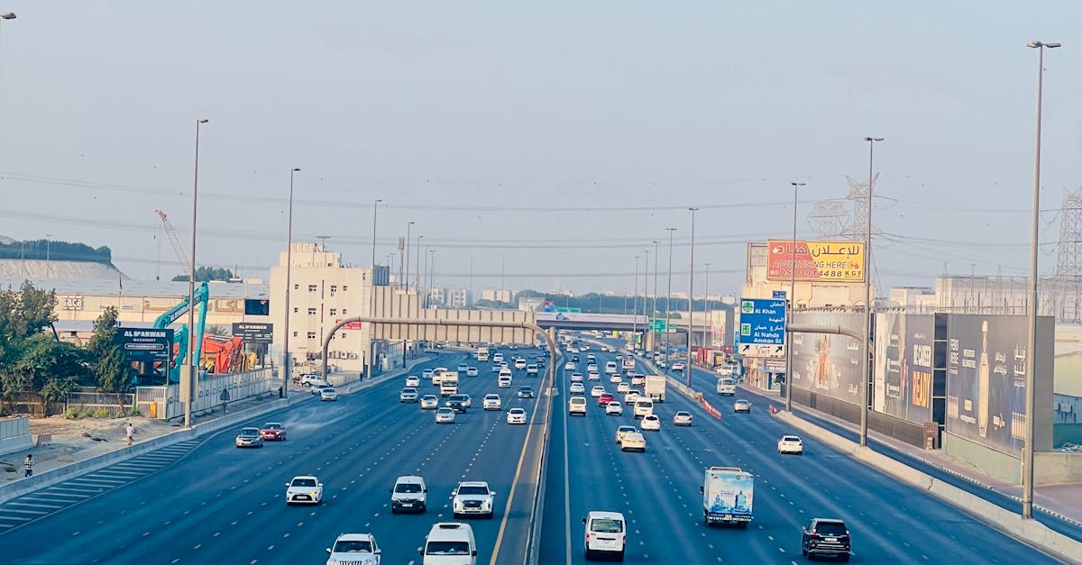 Elevated view of highway traffic in Sharjah, UAE during the day showcasing urban transportation.